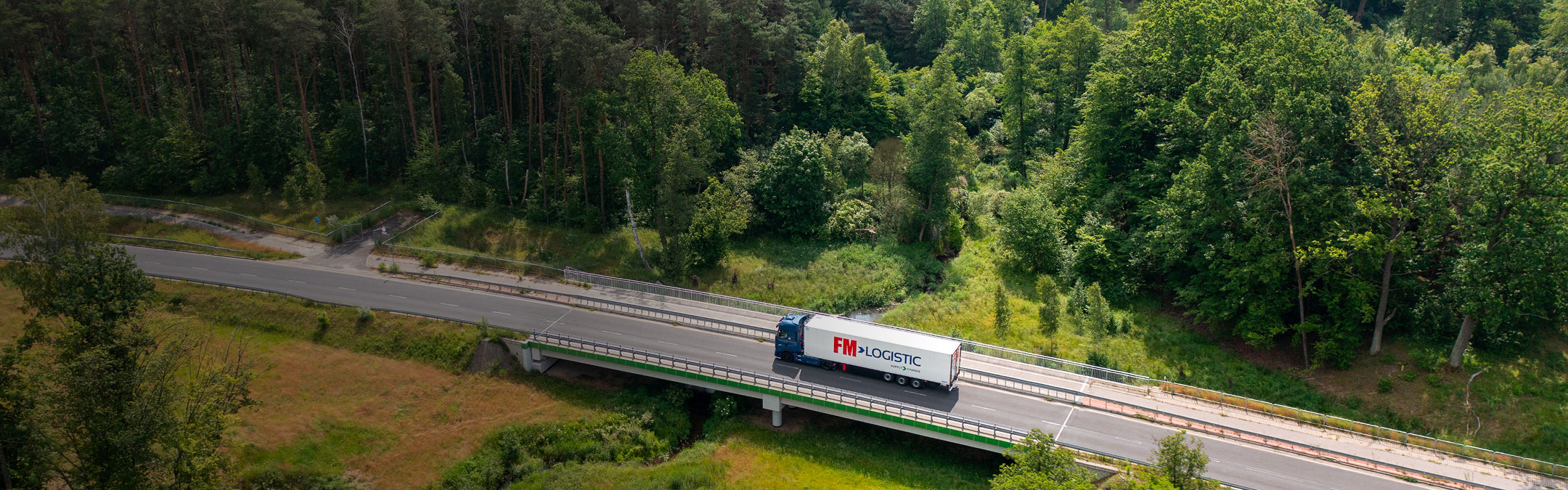 Automotive transport - FM Logistic truck on the road - header desktop format